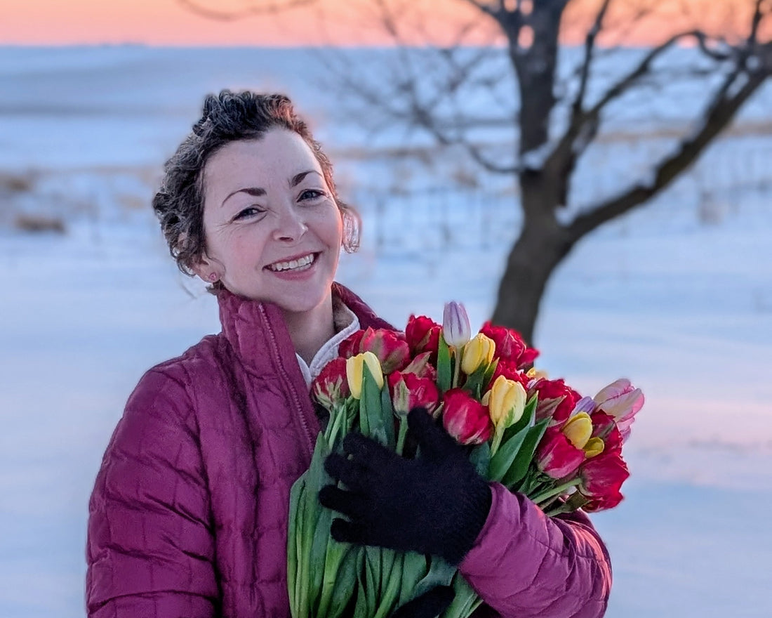 Catherine holding multicolor tulips in snow
